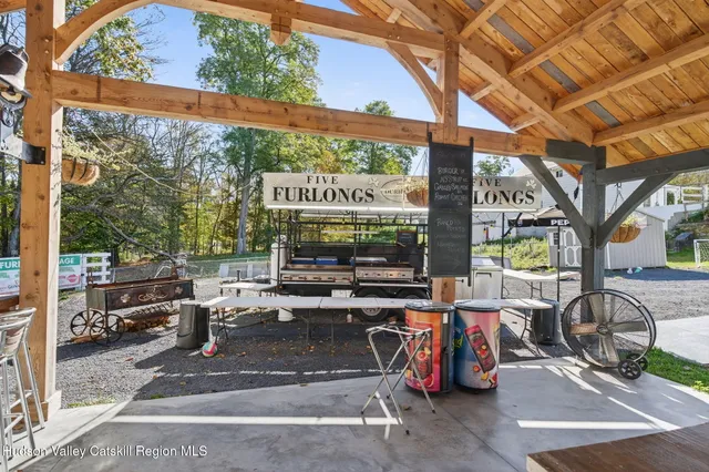 a view of a chair and table in backyard of the house
