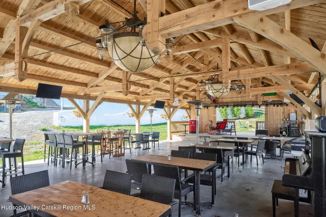 a view of a chairs and tables in the back yard of the house