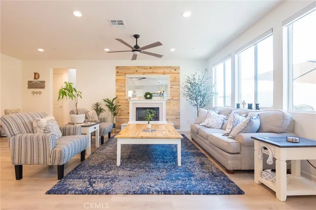 a living room with furniture a large window and a fireplace
