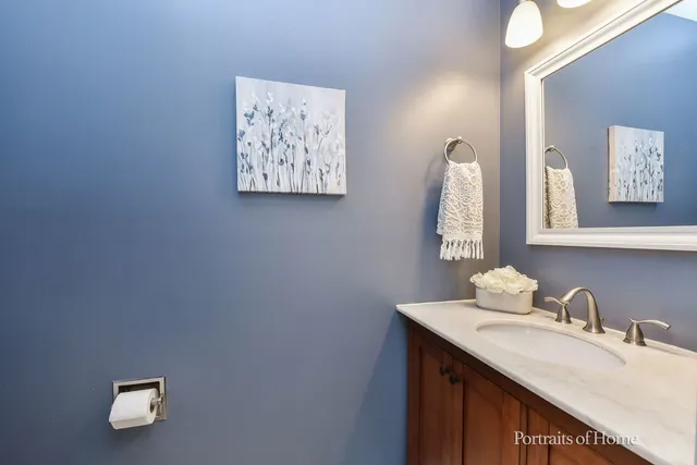 a bathroom with a sink vanity and a mirror