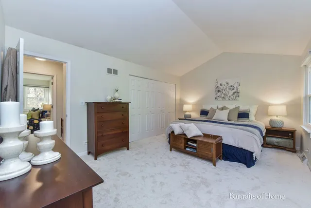 a spacious bedroom with a bed and furniture