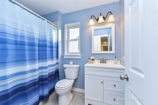 a bathroom with a toilet a sink and a mirror