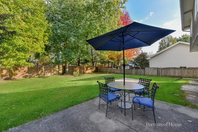 a view of a table and chairs under an umbrella