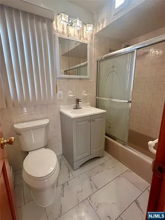 a bathroom with a toilet a sink and a mirror