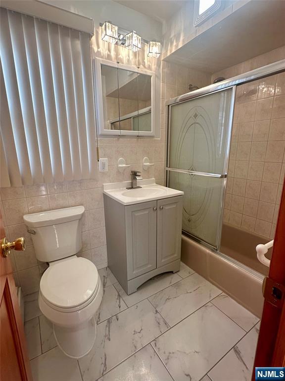 17 Hamilton Street Harrison, NJ 07029 - Photo 11 of 11 a bathroom with a toilet a sink and a mirror