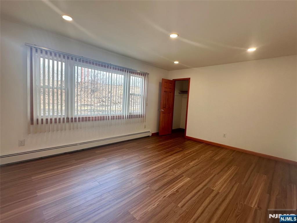 17 Hamilton Street Harrison, NJ 07029 - Photo 4 of 11 a view of an empty room with wooden floor and a window