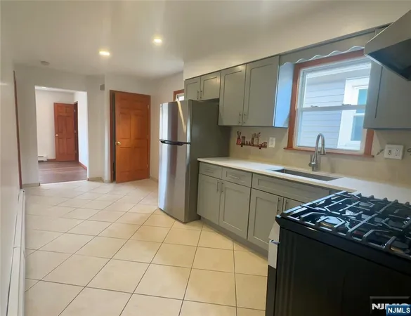 a kitchen with a sink a stove and refrigerator
