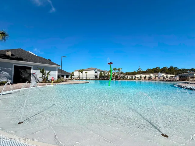 a view of swimming pool with outdoor seating and lake view