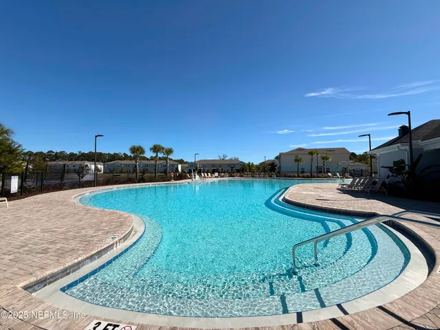 a view of a swimming pool with a yard