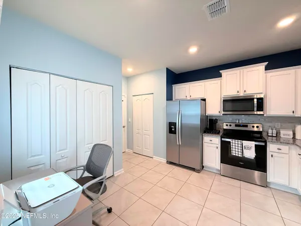 a kitchen with stainless steel appliances a refrigerator sink and cabinets