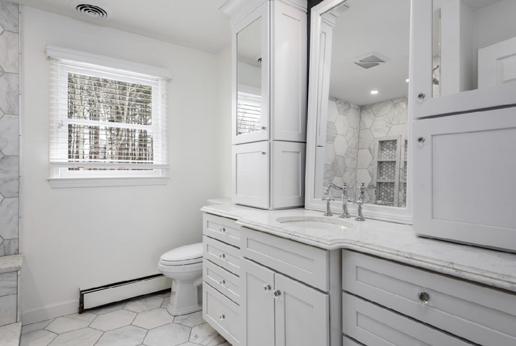 11 Woodman Road Amesbury, MA 01913 - Photo 12 of 31 a bathroom with a granite countertop sink a toilet a mirror and a shower