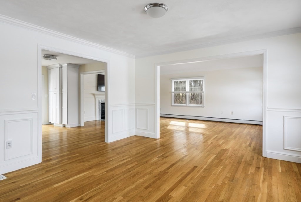 11 Woodman Road Amesbury, MA 01913 - Photo 23 of 31 a view of an empty room with window and wooden floor