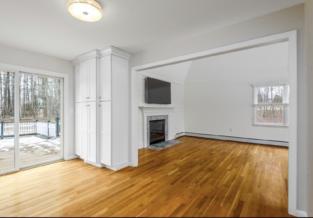 11 Woodman Road Amesbury, MA 01913 - Photo 26 of 31 a view of a livingroom with wooden floor and a fireplace