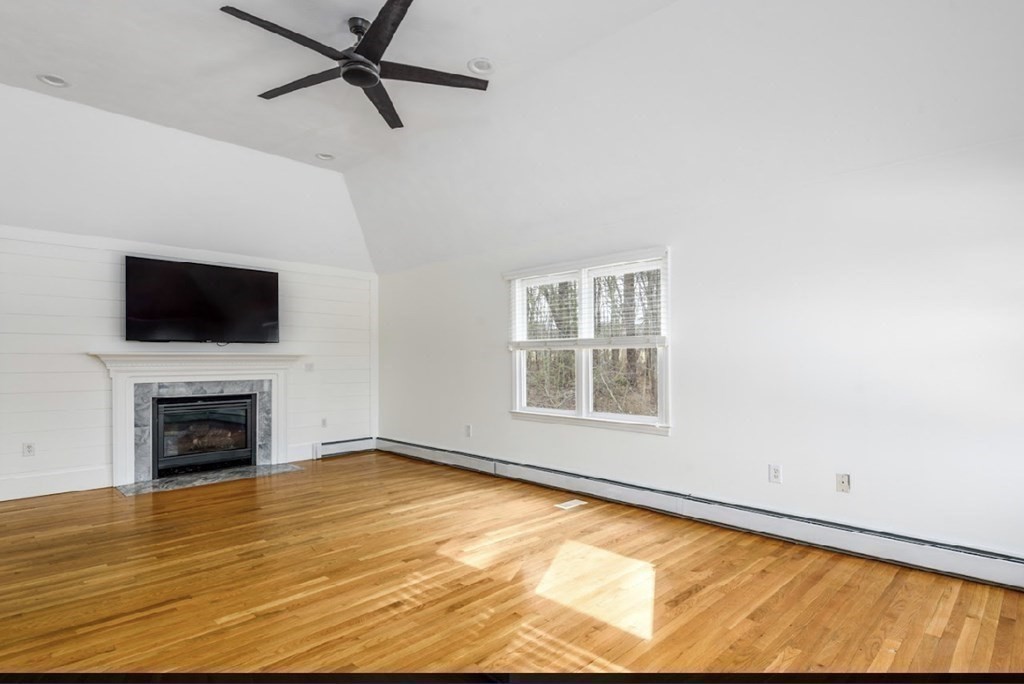 11 Woodman Road Amesbury, MA 01913 - Photo 27 of 31 a view of an empty room with a fireplace and a window