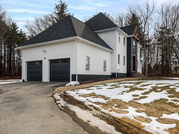 11 Woodman Road Amesbury, MA 01913 - Photo 3 of 31 a view of a white house with a large tree in front of it