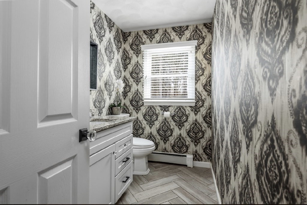 11 Woodman Road Amesbury, MA 01913 - Photo 10 of 31 a bathroom with a toilet a sink and a window