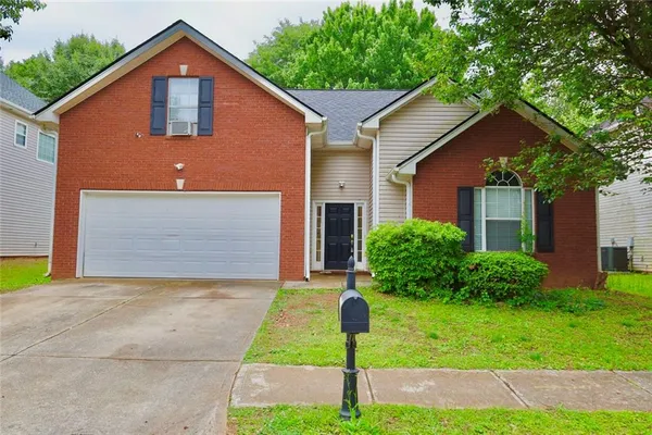 a front view of house with yard and green space