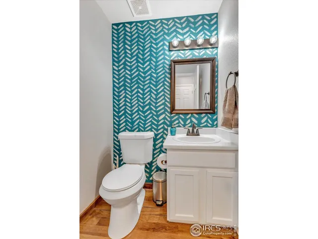 a bathroom with a toilet a sink and a mirror