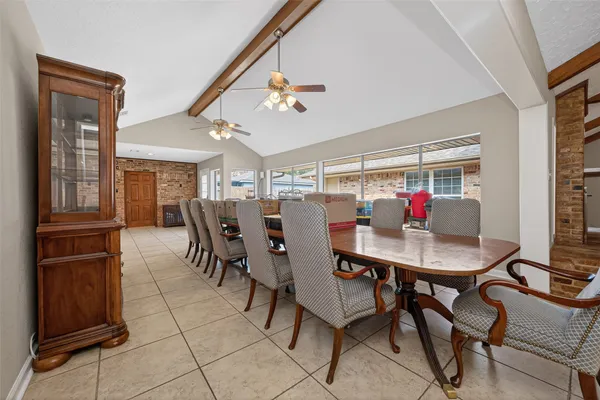 a view of a dining room with furniture and a chandelier