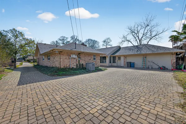 a front view of a house with a yard and trees