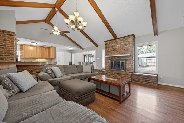 a living room with furniture wooden floor and a fireplace