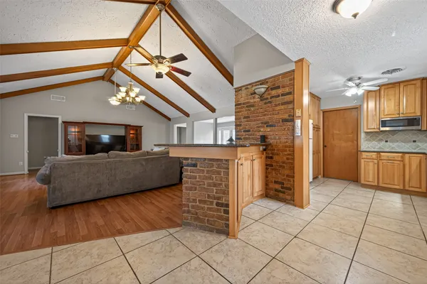 a living room with a couch and a stove top oven