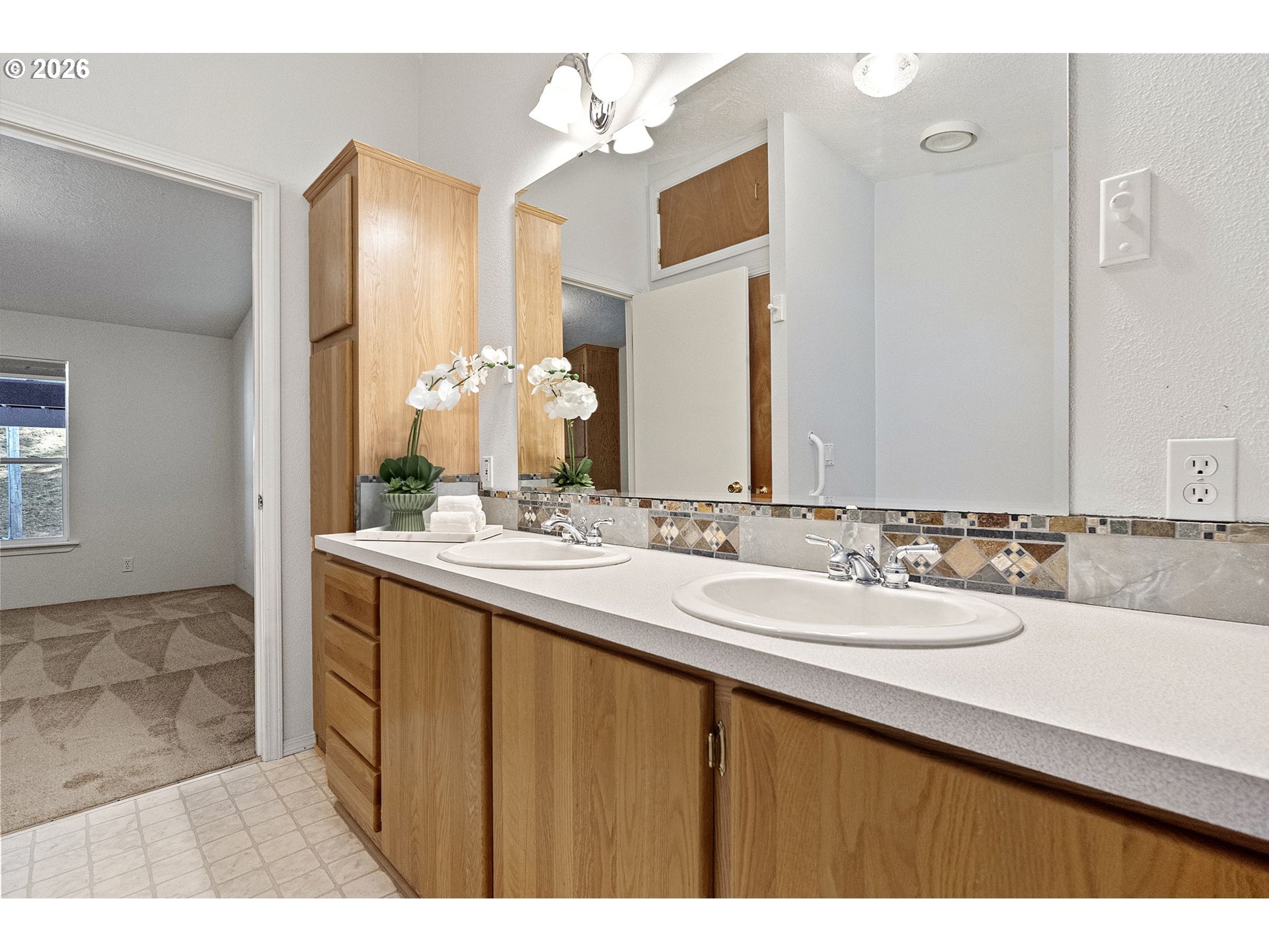 98041 Hallway Road, Unit 41 Brookings, OR 97415 - Photo 21 of 48 a bathroom with a double vanity sink and a mirror