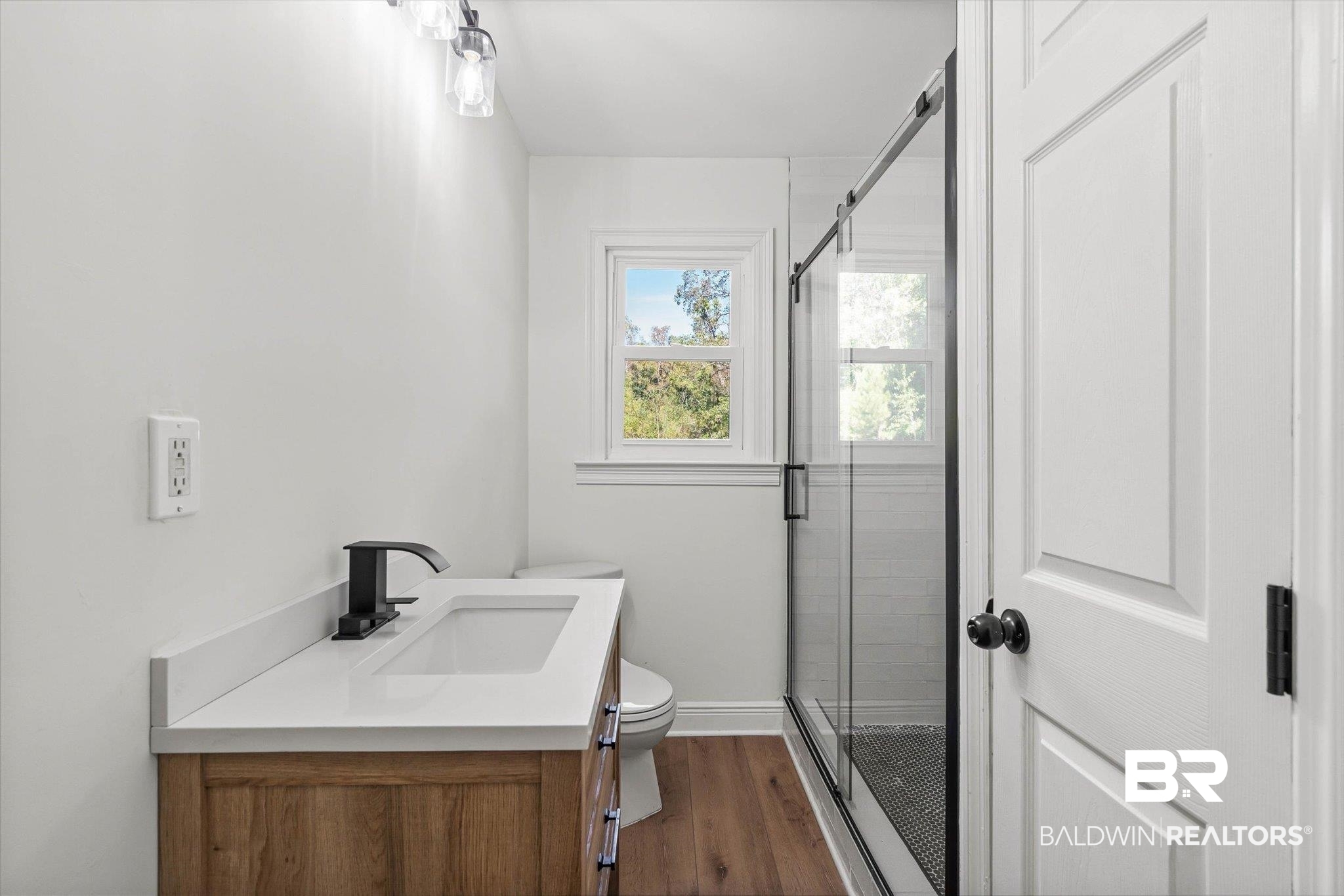 4156 Furman Drive Mobile, AL 36619 - Photo 14 of 24 Bathroom with a stall shower, vanity, and dark wood-style flooring