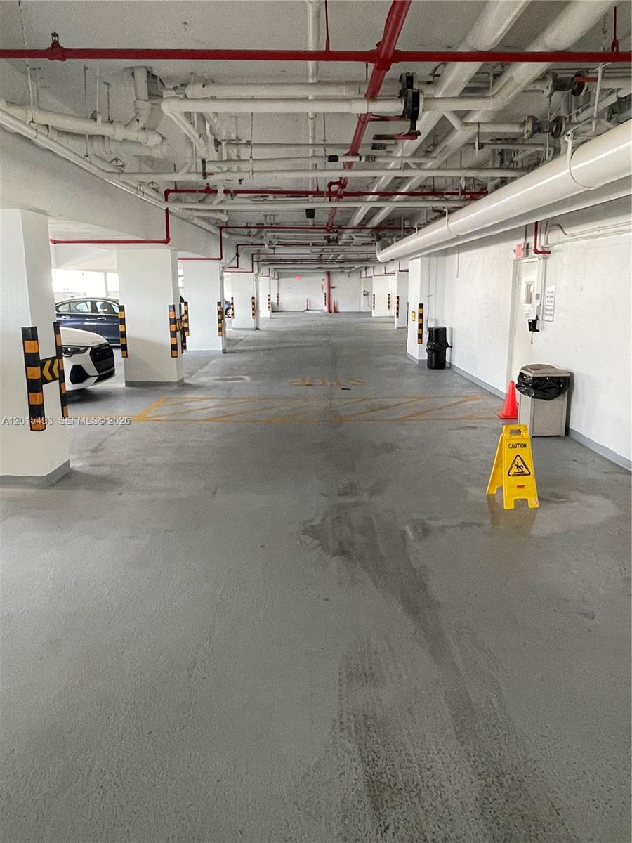 9195 Collins Avenue, Unit 1012 Surfside, FL 33154 - Photo 16 of 27 a view of parking garage with cars