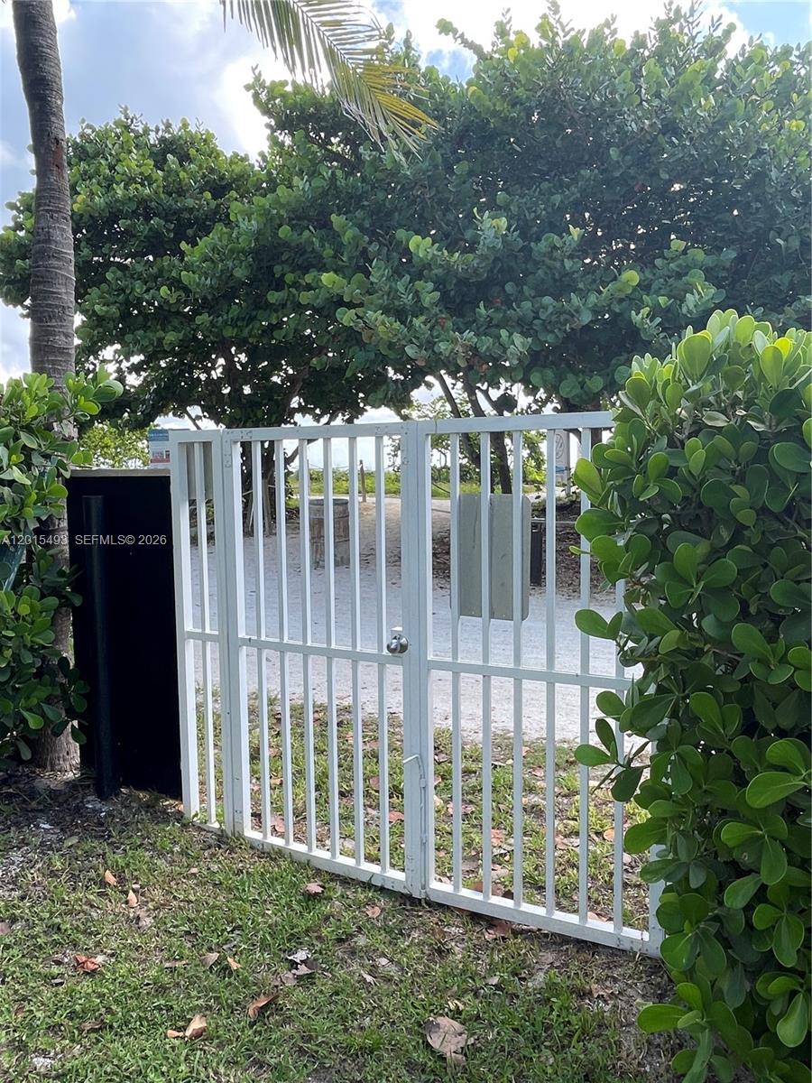 9195 Collins Avenue, Unit 1012 Surfside, FL 33154 - Photo 26 of 27 a view of a house with a small yard and plants
