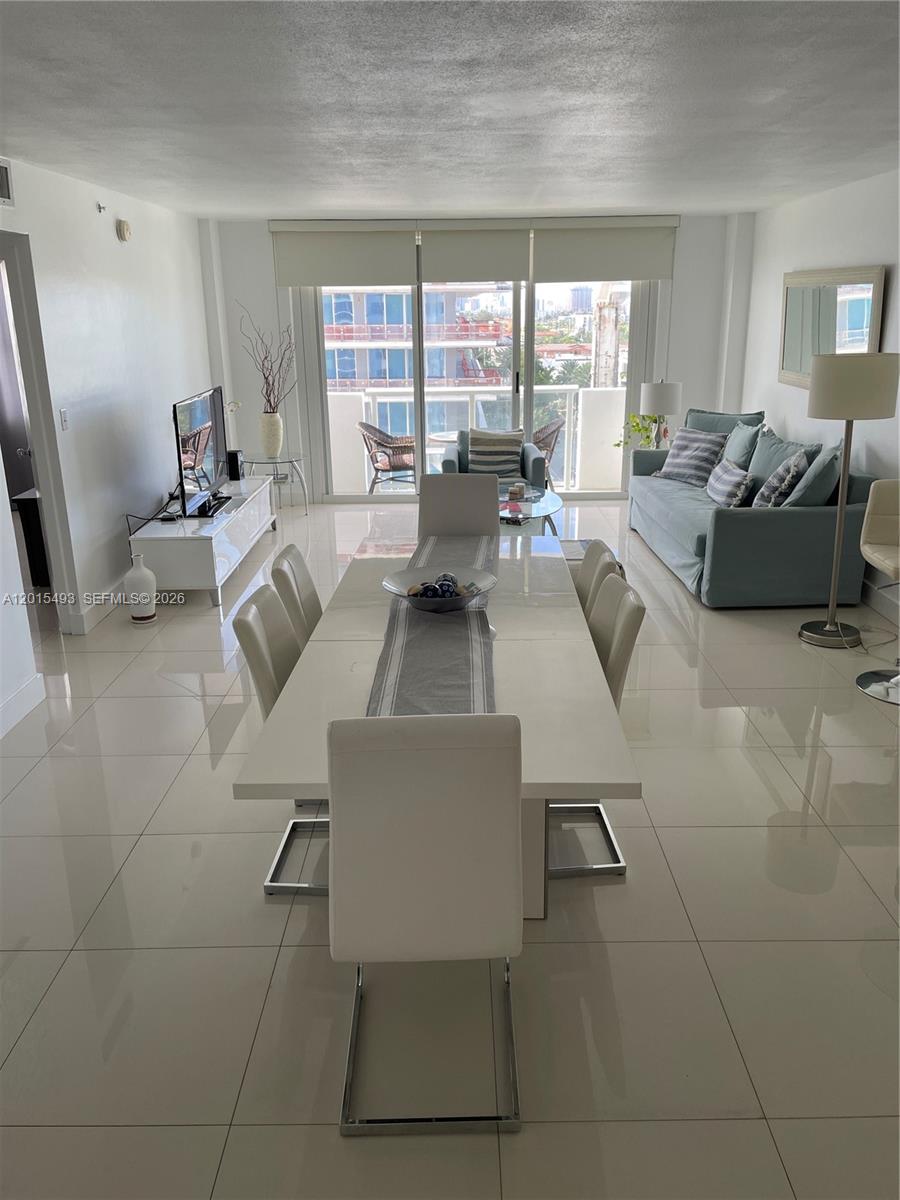 9195 Collins Avenue, Unit 1012 Surfside, FL 33154 - Photo 3 of 27 a living room with furniture and a large window