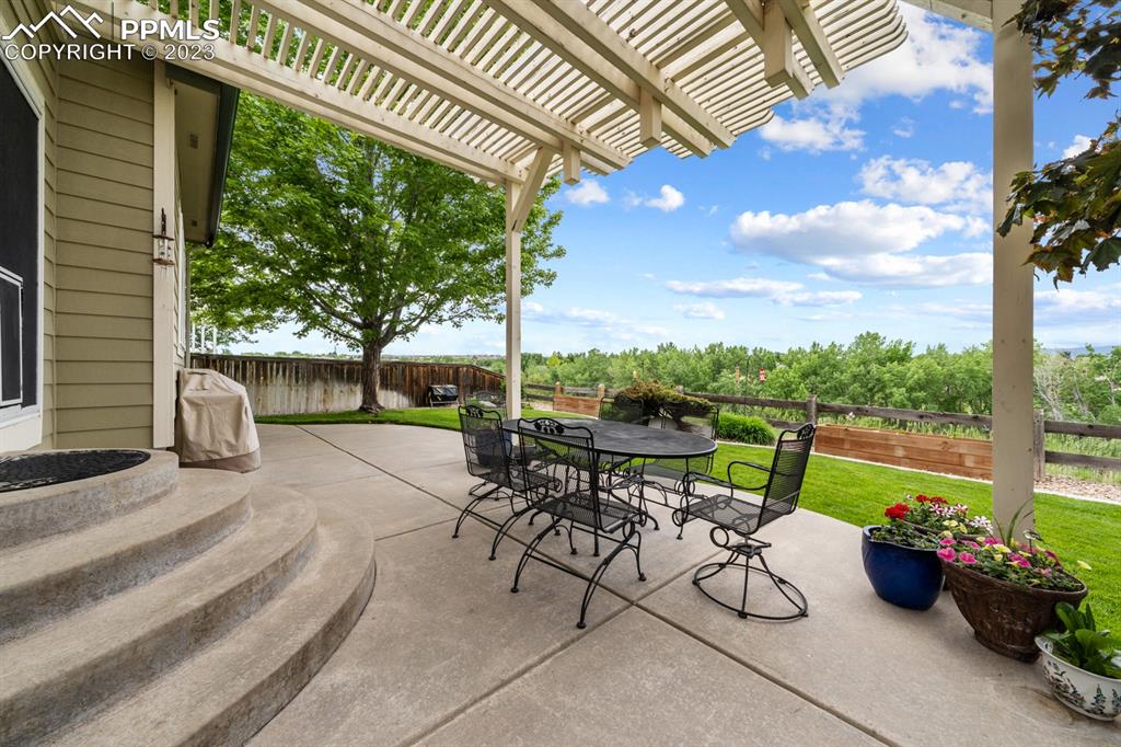 1104 Riddlewood Road Highlands Ranch, CO 80129 - Photo 12 of 19 a view of a patio with a table chairs and a backyard