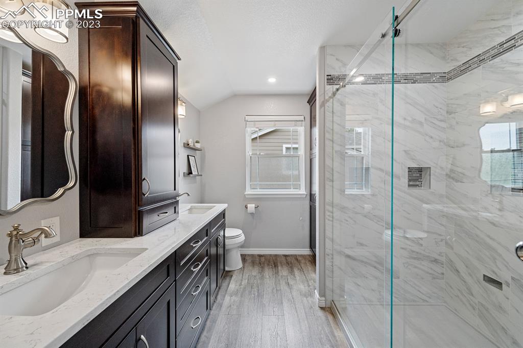 1104 Riddlewood Road Highlands Ranch, CO 80129 - Photo 9 of 19 a bathroom with a double vanity sink a mirror and a shower