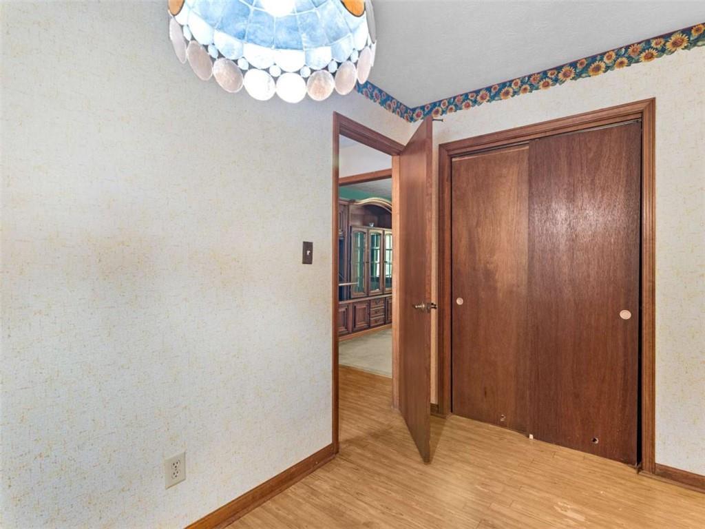 8294 Winston Way Jonesboro, GA 30236 - Photo 16 of 67 a view of a hallway with wooden floor and a chandelier
