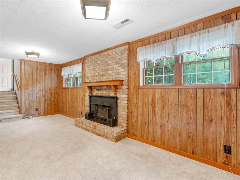 8294 Winston Way Jonesboro, GA 30236 - Photo 30 of 67 an empty room with windows a fireplace and garden view