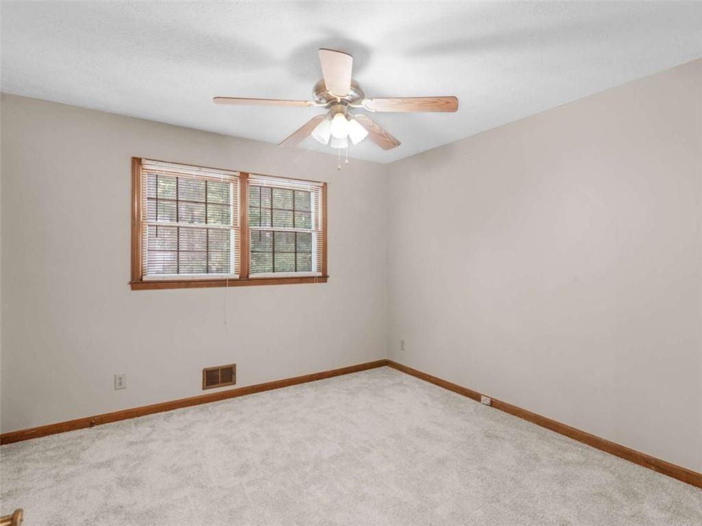 8294 Winston Way Jonesboro, GA 30236 - Photo 34 of 67 an empty room with a window and a fan