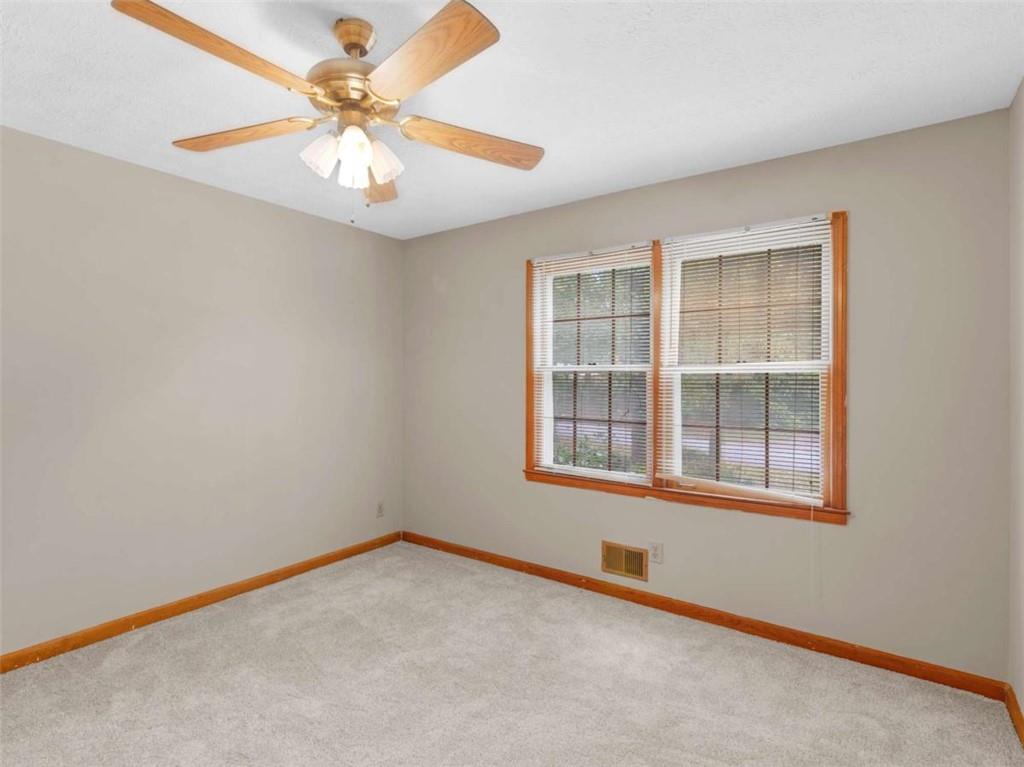 8294 Winston Way Jonesboro, GA 30236 - Photo 39 of 67 an empty room with chandelier fan and windows