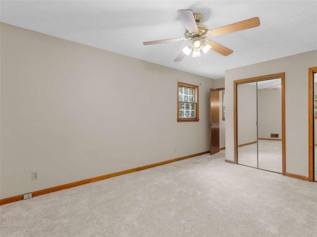 8294 Winston Way Jonesboro, GA 30236 - Photo 50 of 67 an empty room with a chandelier fan and windows