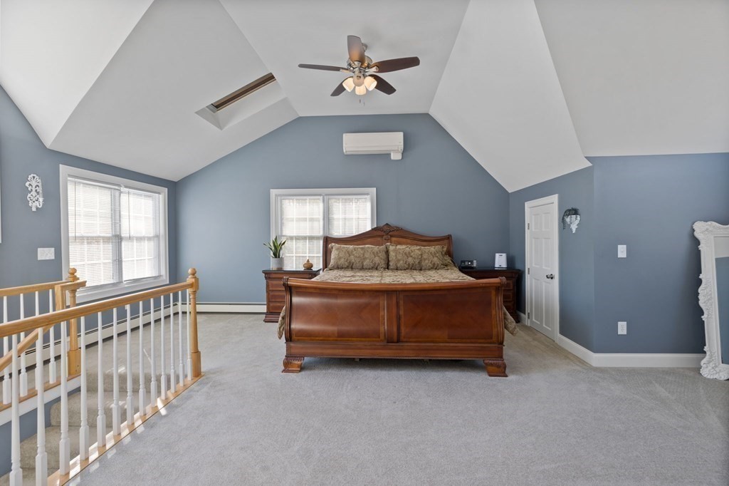 37 Lincoln Street Norton, MA 02766 - Photo 22 of 42 a bedroom with a bed and a chandelier
