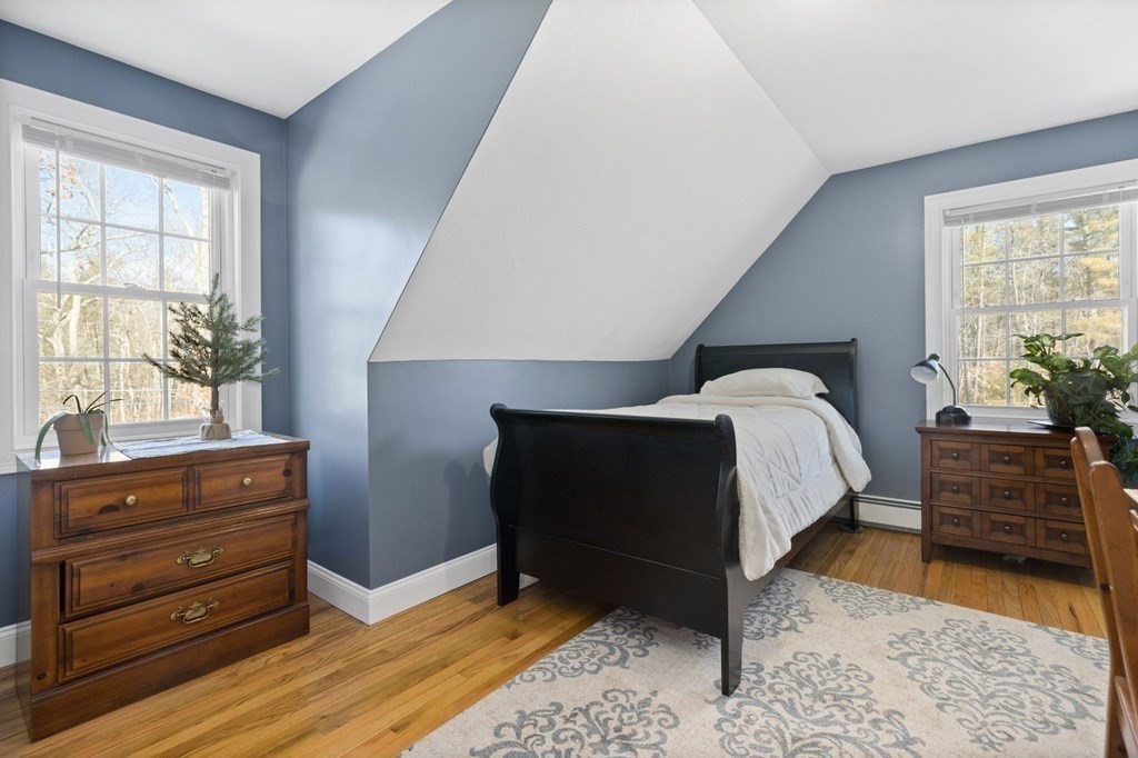 37 Lincoln Street Norton, MA 02766 - Photo 30 of 42 a bed sitting in a bedroom next to a window with dresser