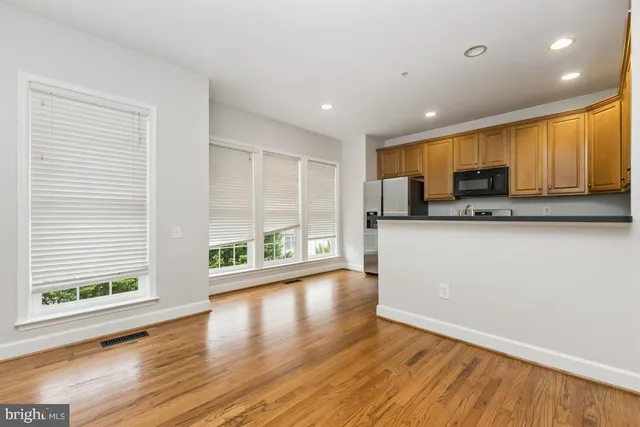 a kitchen with granite countertop a stove top oven a sink and a granite counter top space