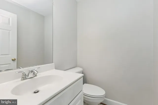 a bathroom with a sink a toilet and mirror
