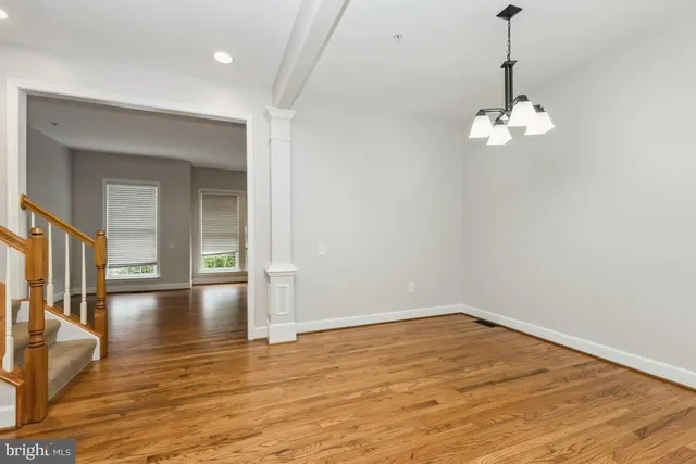 a view of a room with wooden floor chandelier and entryway