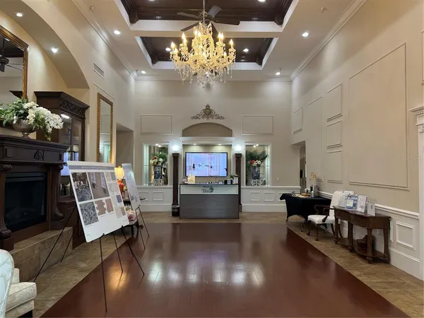 a living room with fireplace furniture and a chandelier