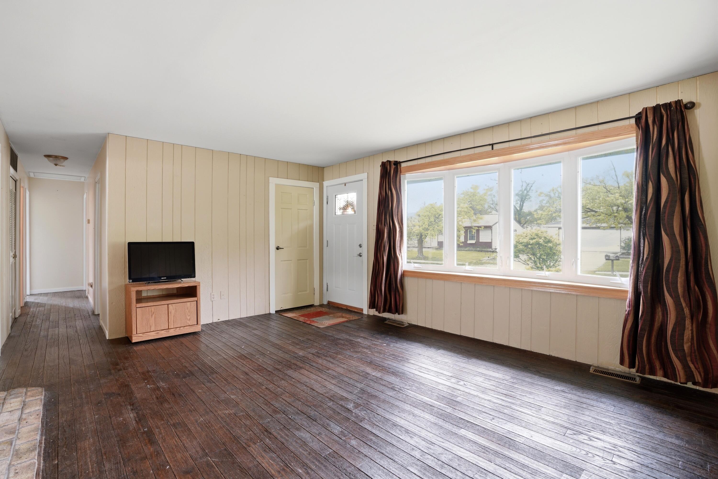 627 Olympia Road Valparaiso, IN 46385 - Photo 6 of 19 an empty room with wooden floor and windows