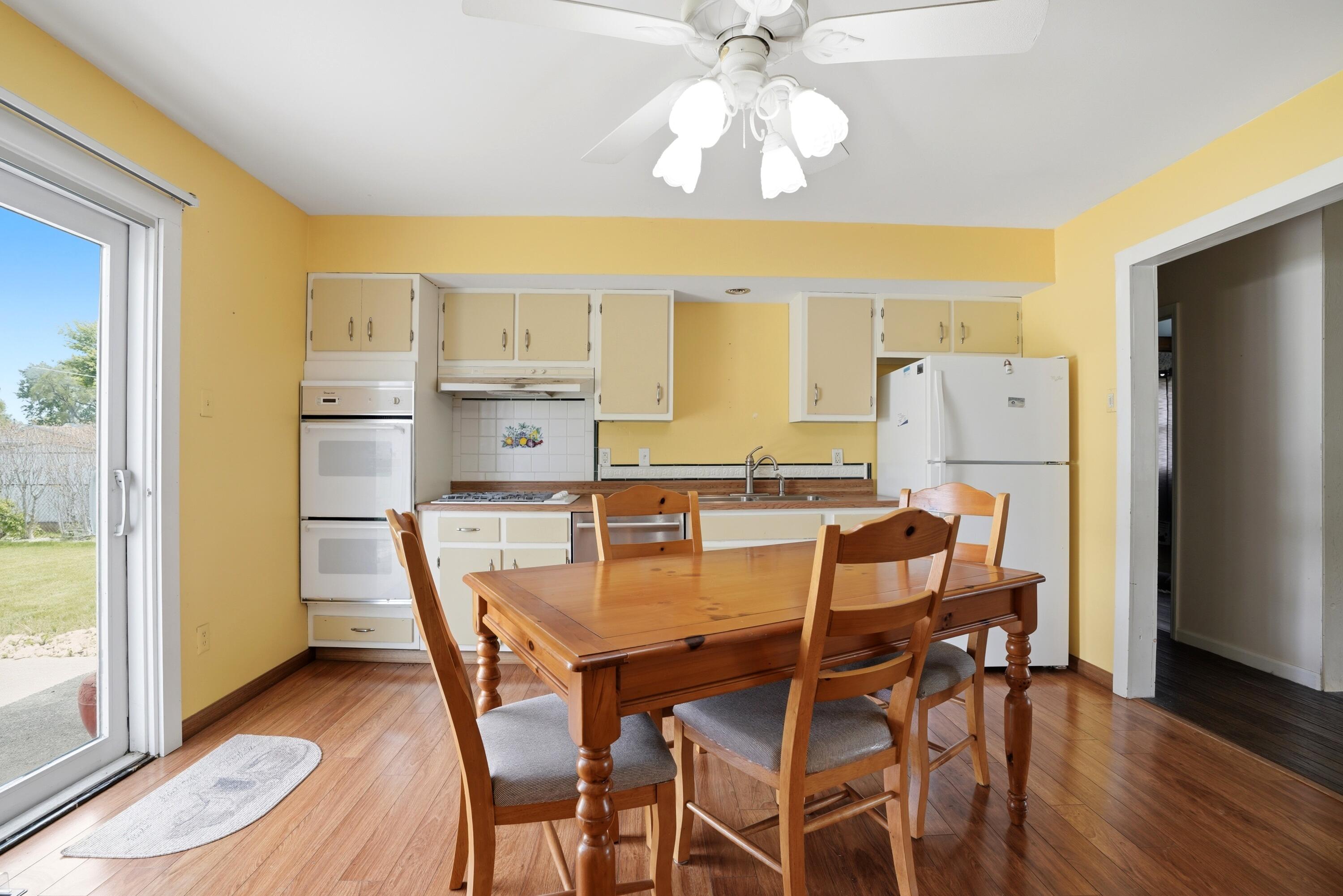 627 Olympia Road Valparaiso, IN 46385 - Photo 7 of 19 a dining room with furniture a chandelier and wooden floor