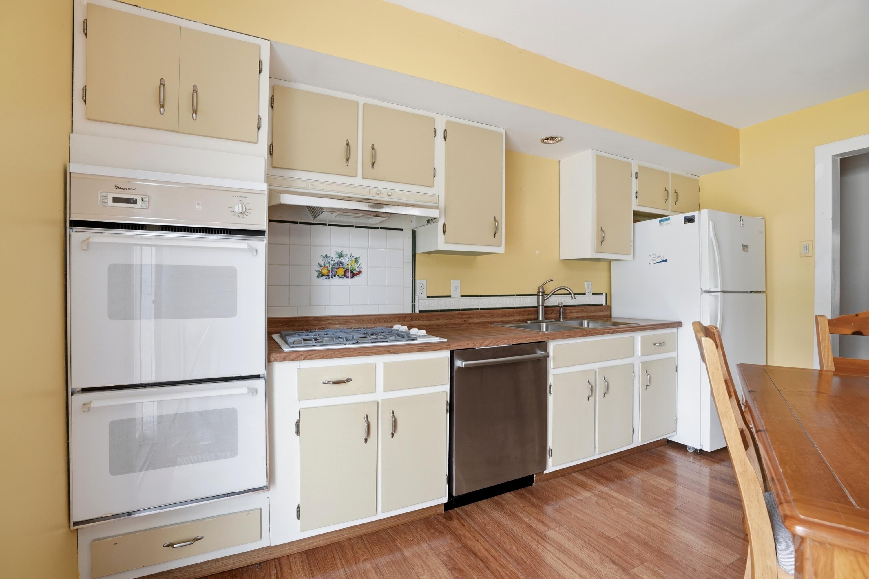 627 Olympia Road Valparaiso, IN 46385 - Photo 8 of 19 a kitchen with white cabinets and white appliances