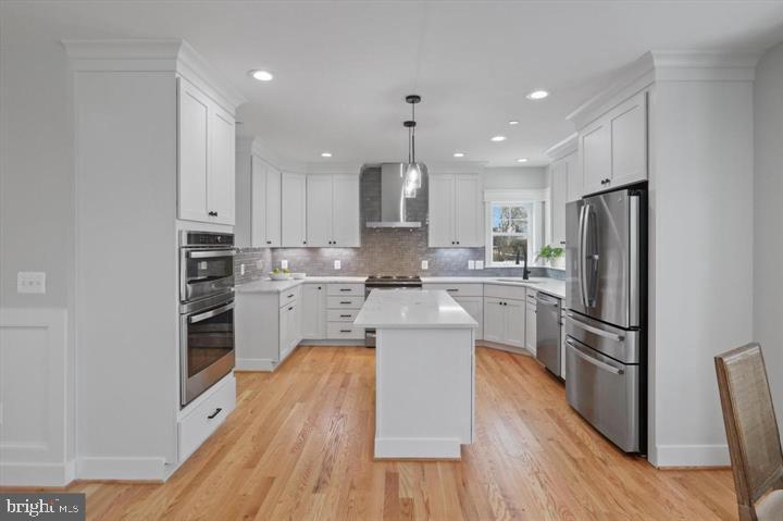 2806 Norbeck Road Silver Spring, MD 20906 - Photo 4 of 41 a kitchen with white cabinets and stainless steel appliances
