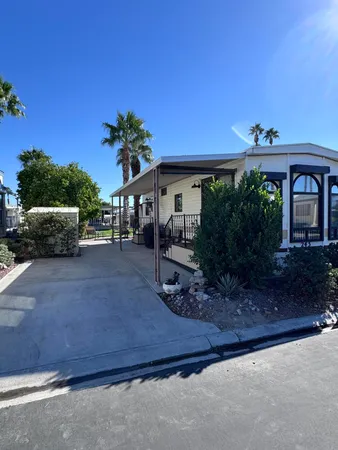 a view of a house with backyard and sitting area
