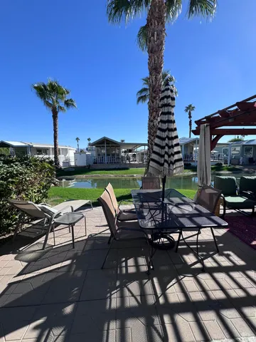 a view of a patio with a table chairs and a fire pit